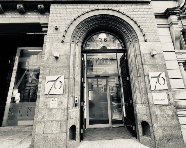 Black and white photo of a building with a central door.