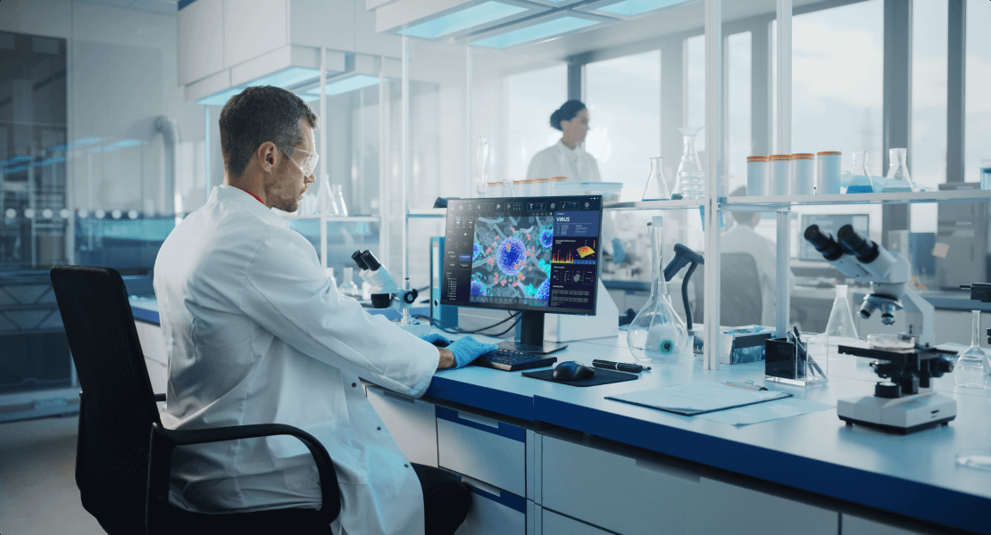 Man working on a computer in a science lab