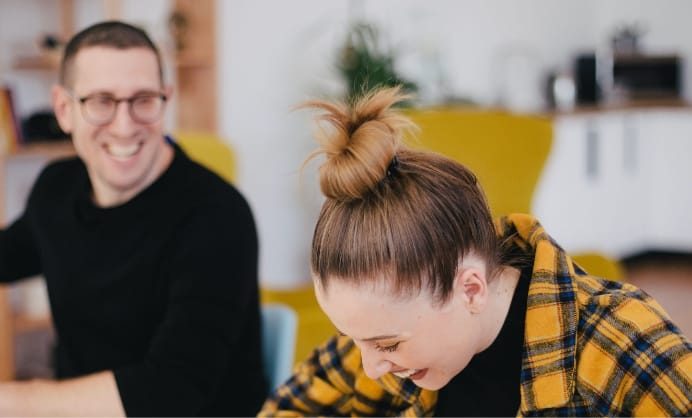 People laughing while working in an office setting