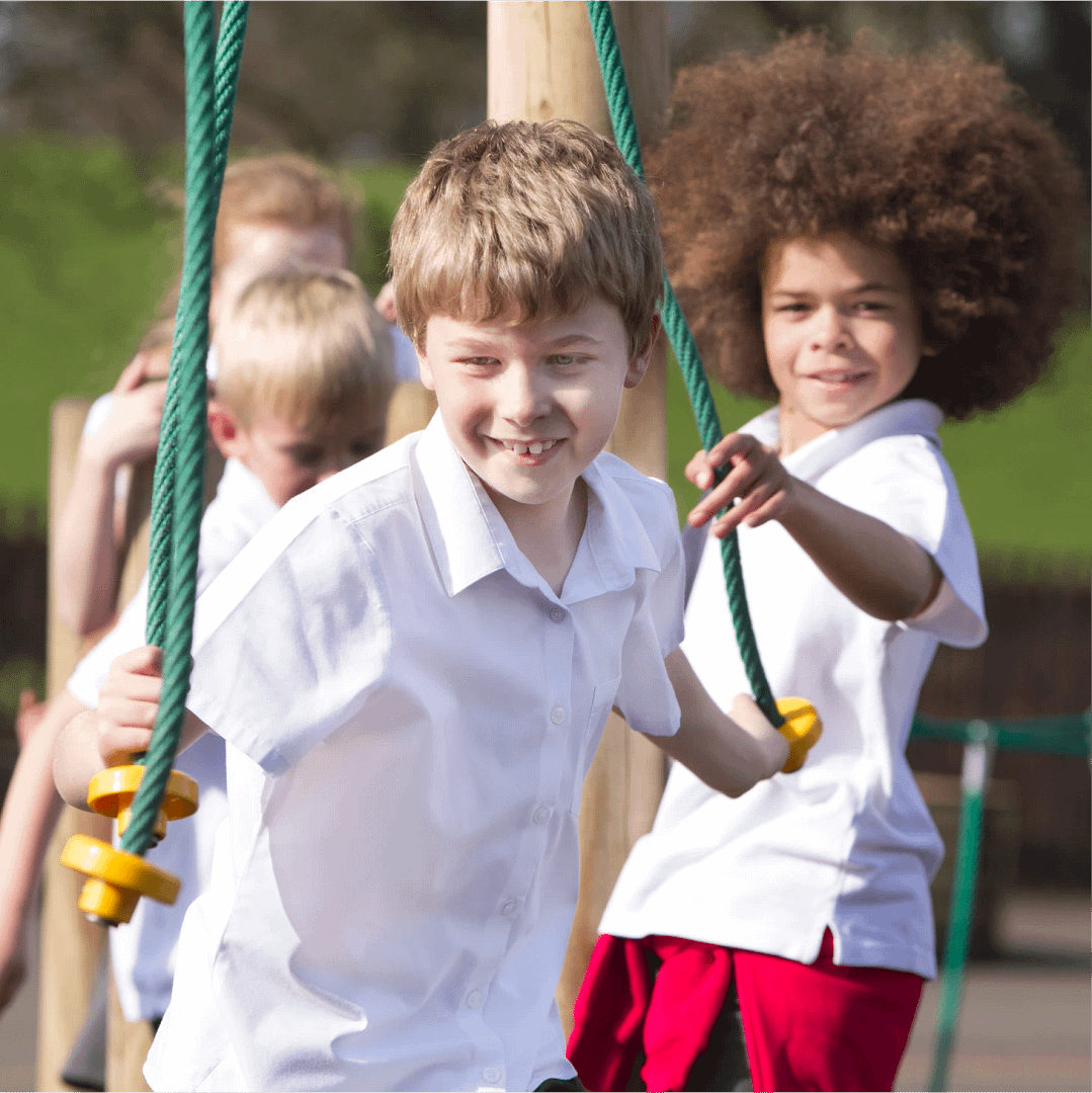 A group of school children playing together on outdoor climbing equipment.