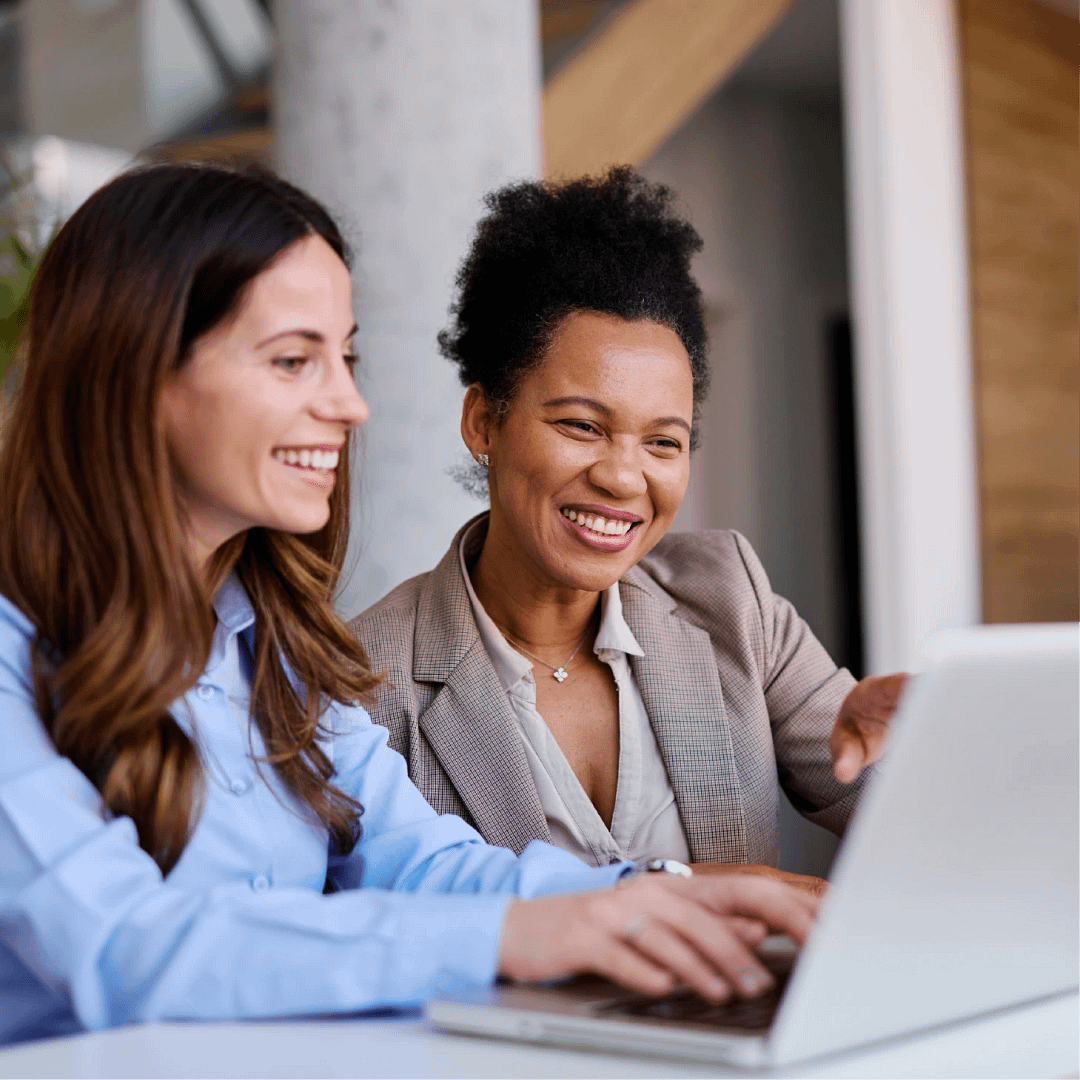 Two business women working together at a laptop.