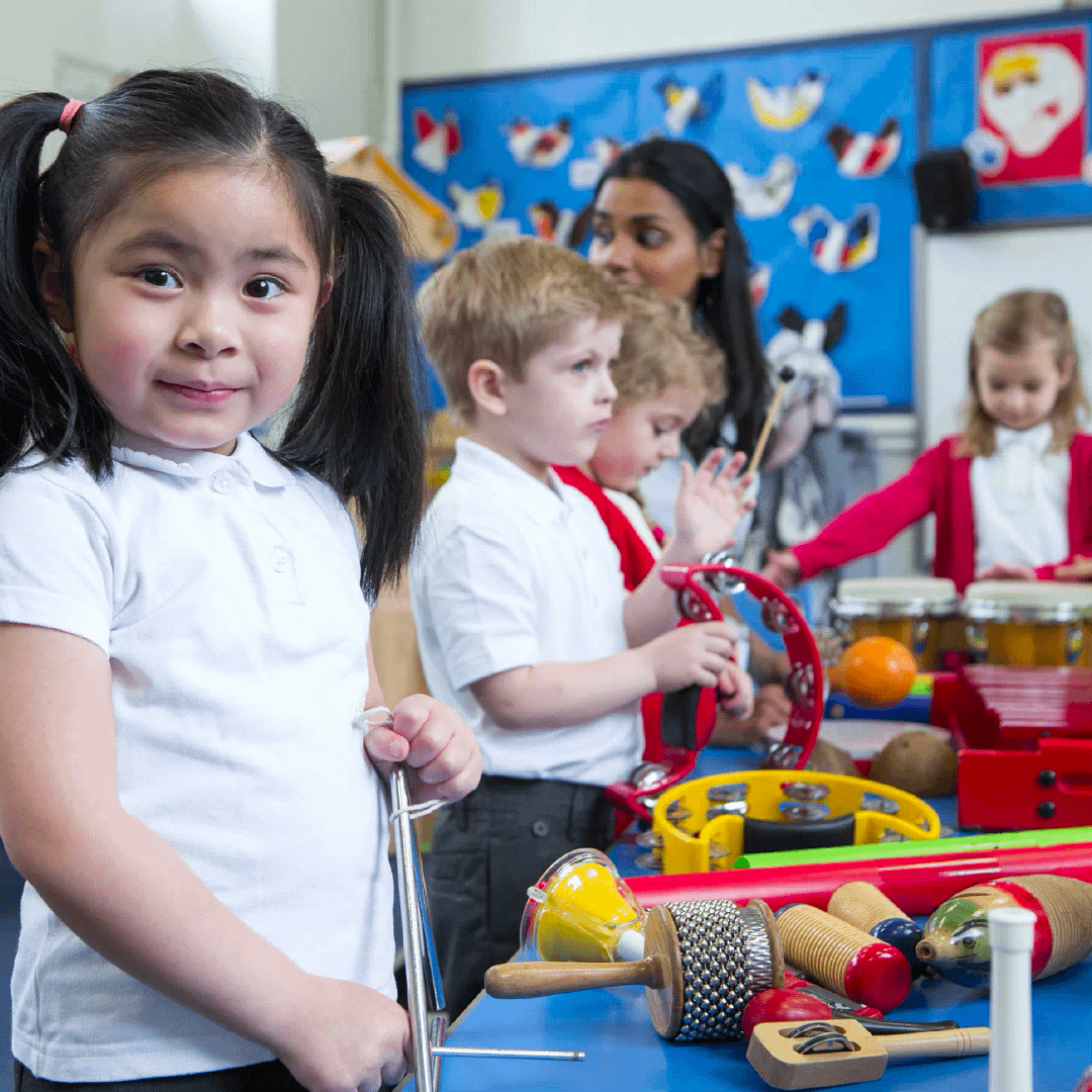 Young primary children exploring a range of instruments around a table