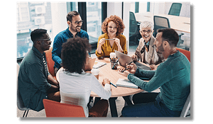 Men and women gathered around a table for a meeting