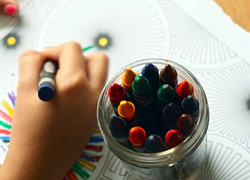 Child's hand drawing with crayons