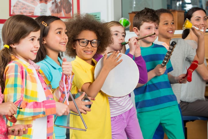 Children playing various instrument in a music class