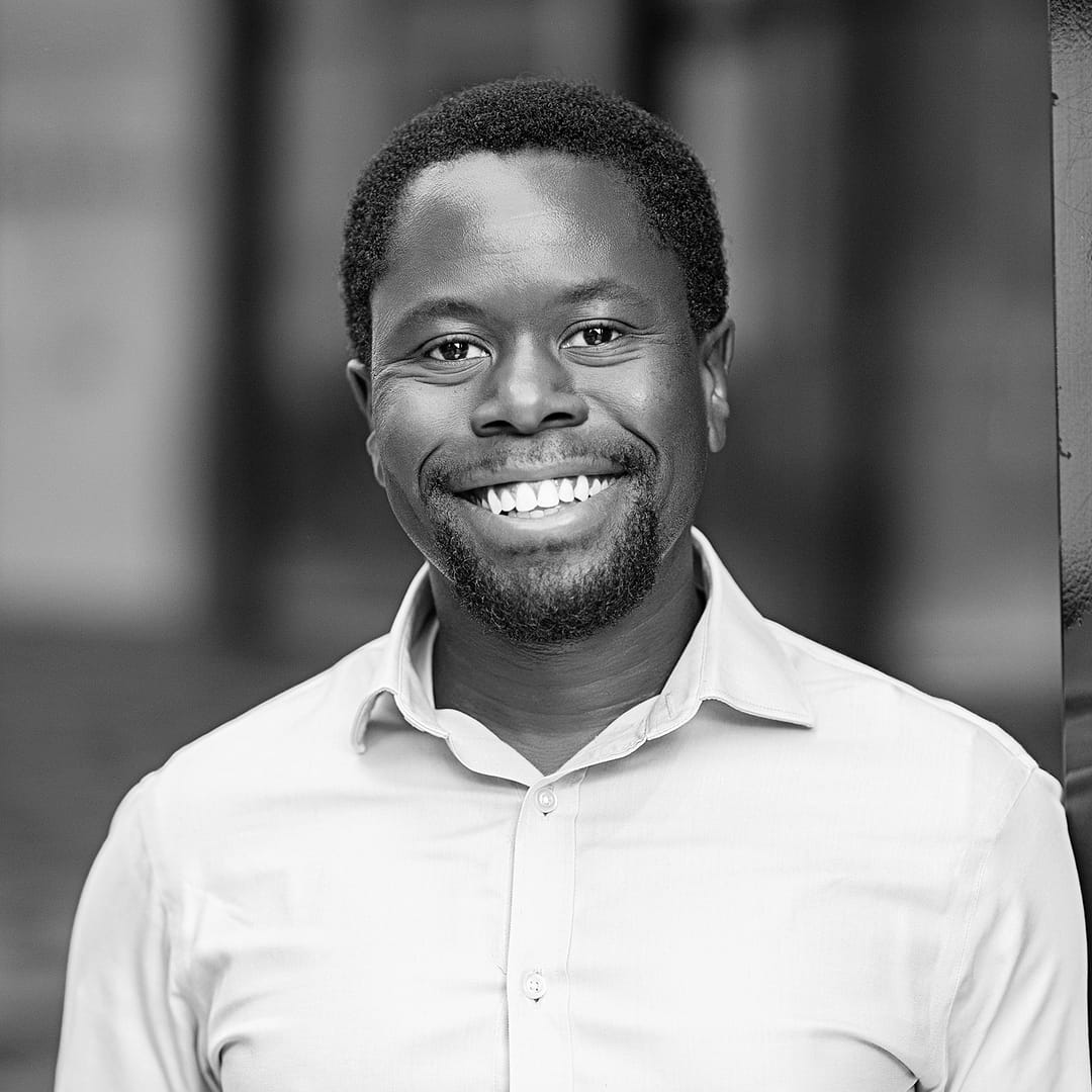 Black and white formal headshot of Iyobosa Adeghe.