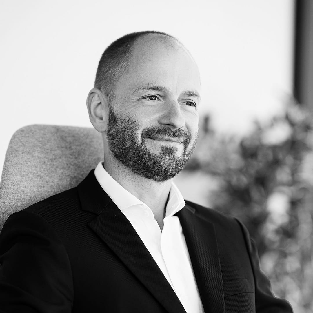 Black and white formal headshot of Martins Marnauza.