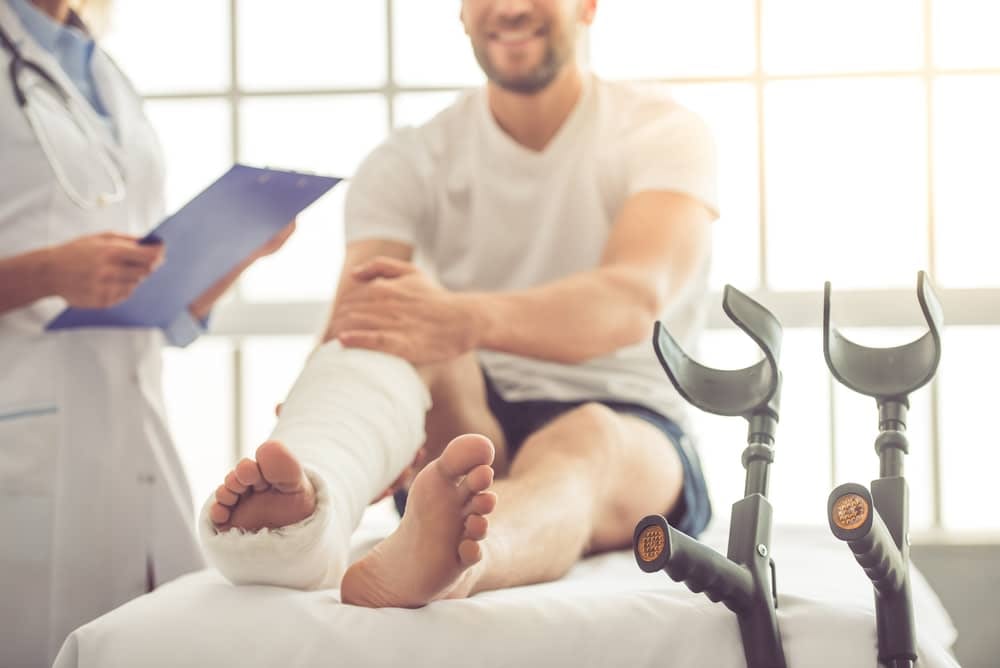 Man with fractured leg being treated