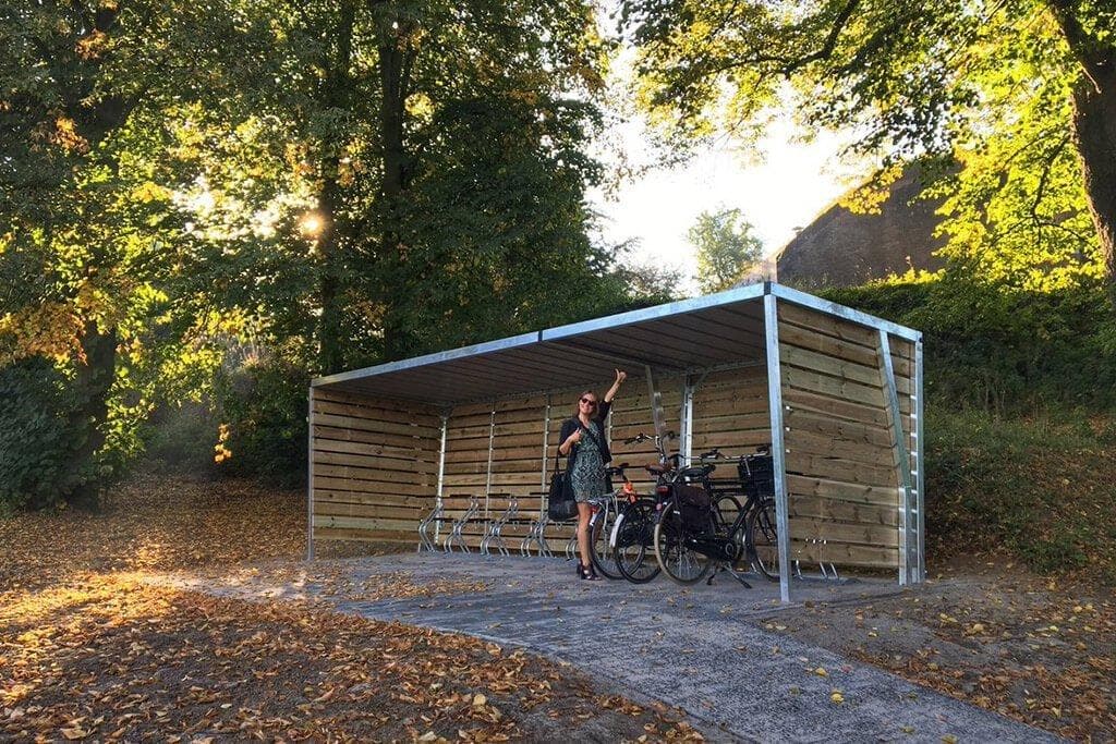 Open wooden bike shed with steel supports